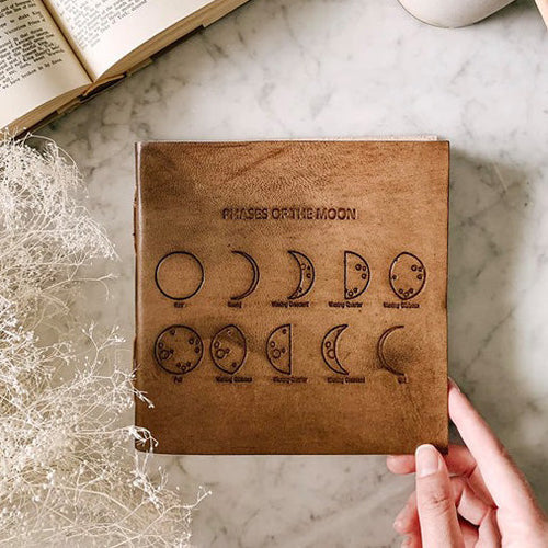 Load image into Gallery viewer, Moon Phases 7x7 Artists Embossed Leather Journal by Soothi
