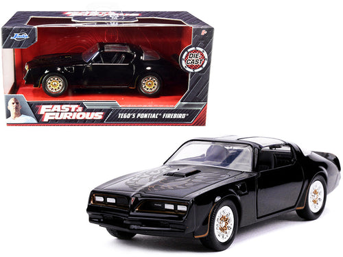 Load image into Gallery viewer, Tego's Pontiac Firebird Black with Gold Stripes and Hood Bird "Fast &amp; Furious" Series 1/32 Diecast Model Car by Jada
