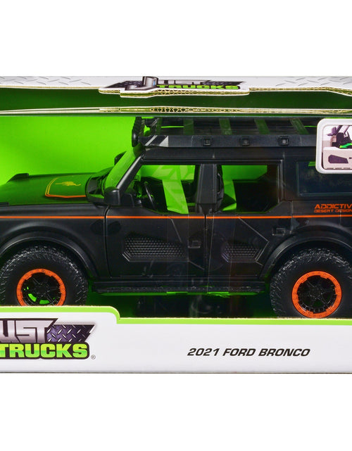Load image into Gallery viewer, 2021 Ford Bronco Matt Black with Orange Stripes and Roof Rack "Addictive Desert Designs" "Just Trucks" Series 1/24 Diecast Model Car by Jada
