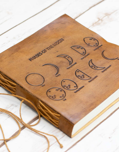 Load image into Gallery viewer, Moon Phases 7x7 Artists Embossed Leather Journal by Soothi
