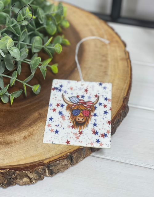 Load image into Gallery viewer, Stars &amp; Stripes Highland Cow Car Freshener by CMD Wholesale
