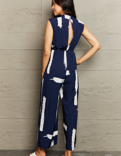 Load image into Gallery viewer, Perfee Printed Round Neck Cutout Jumpsuit with Pockets
