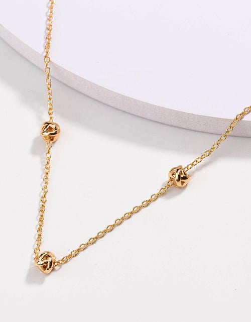 Load image into Gallery viewer, Gold Love Knot Necklace by Hollywood Sensation®

