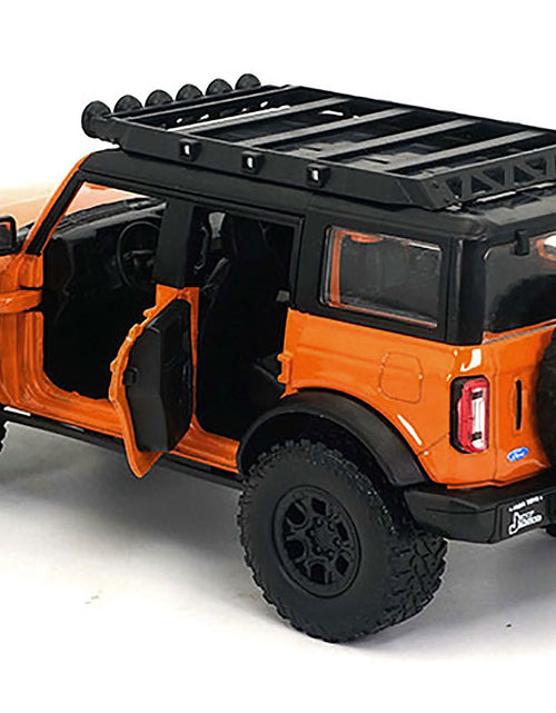 Load image into Gallery viewer, 2021 Ford Bronco Orange with Black Stripes and Roof Rack "Just Trucks" Series 1/24 Diecast Model Car by Jada
