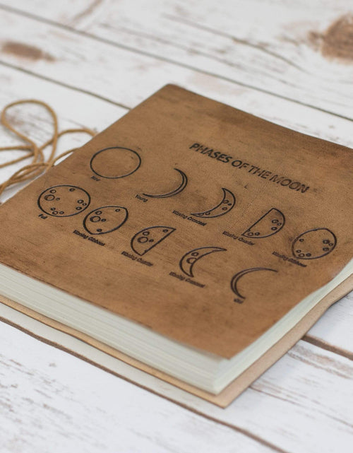 Load image into Gallery viewer, Moon Phases 7x7 Artists Embossed Leather Journal by Soothi
